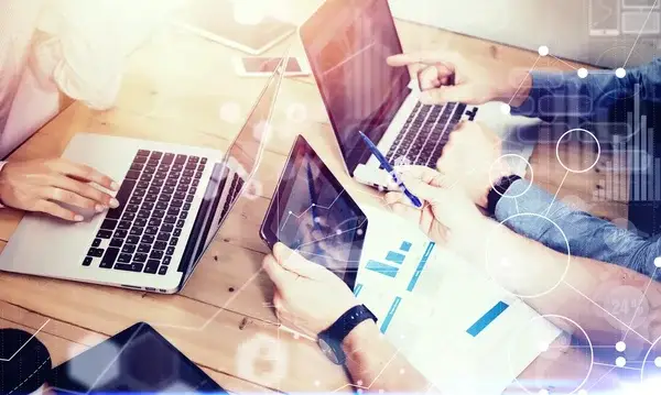 tres trabajadores en sus laptops viendo el CRM en áreas claves de la empresa